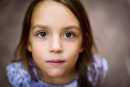Portrait,Of,Little,Girl,Looking,Up,At,The,Parent,Outdoors.
